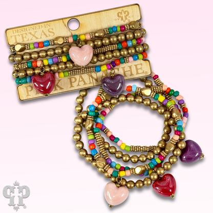 Multi-color bracelet with three heart charms